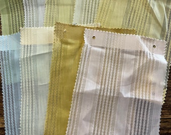 May include: A collection of 10 fabric swatches in various shades of green, yellow, and white. The fabric has a striped pattern with a delicate woven texture.