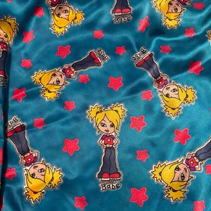 May include: A turquoise blue satin fabric with a repeating pattern of cartoon girls with blonde hair and pink stars. The girls are wearing blue jeans, red shirts, and white shoes. The text "Babe" appears below each girl.