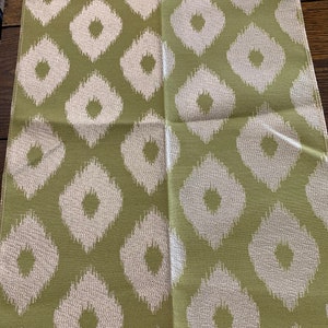May include: A fabric swatch with a green background and a white diamond pattern. The fabric is called "Empress Lime" and the sample number is 5649.