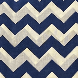 May include: A fabric with a chevron pattern in navy blue and white.