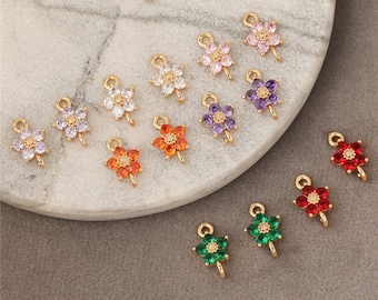 May include: Assortment of gold flower charms with colorful crystal accents. The charms have a loop for attaching to jewelry or other crafts.