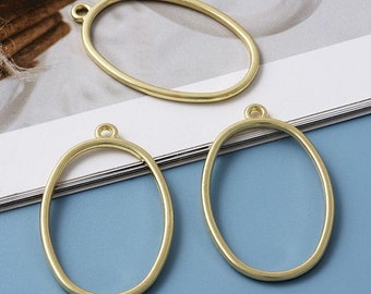 May include: Three gold oval-shaped metal frames with a loop at the top for hanging. The frames are perfect for resin crafts.