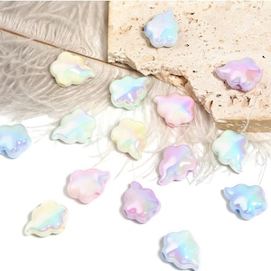 May include: Assortment of iridescent pastel cloud shaped beads. The beads are made of glass and have a pearlescent finish.