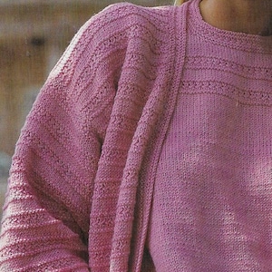 May include: A pink knitted cardigan with a ribbed texture and a matching pink knitted top. The cardigan has a V-neck and long sleeves.