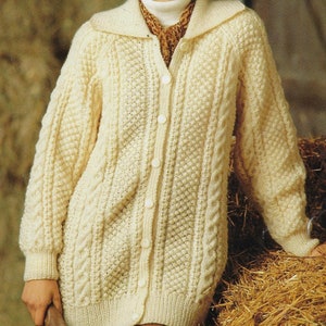 May include: A cream-colored knitted cardigan with a cable knit pattern and a button-up front.