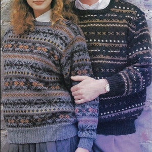 May include: Two crew neck sweaters with detailed geometric patterns. One is grey with orange and black, the other dark blue with white and brown. Both have ribbed cuffs and hems, suggesting a knitted design. The sweaters are suitable for autumn or winter.