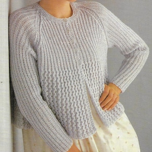 May include: A light grey knitted cardigan with a button fastening and a slightly flared hem.