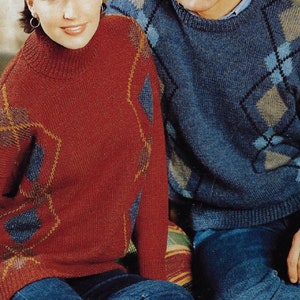 May include: A couple wearing sweaters with geometric patterns. The woman's sweater is red with blue and gold accents. The man's sweater is blue with beige and blue accents.