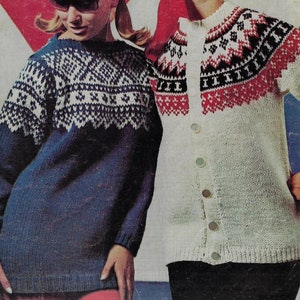 May include: Two knitted sweaters. One is a dark blue sweater with white geometric patterns on the upper chest and shoulders. The other is a white cardigan with red and black geometric patterns on the upper chest and shoulders. Both sweaters have long sleeves.