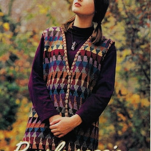 May include: A colorful knitted vest with a geometric pattern in shades of purple, blue, brown, and beige. The vest has a button closure and is worn over a purple turtleneck shirt. The text "Purple passion" is written in a stylized font at the bottom of the image.