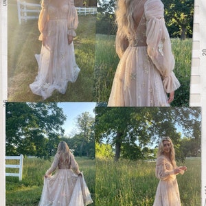 May include: A woman wearing a long, flowing, light pink dress with gold stars. The dress has a V-neckline and long sleeves. The woman is standing in a field of green grass. The caption reads "unedited photos of Starlight to showcase color in real life".
