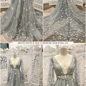 May include: A gray tulle gown with long sleeves and a plunging neckline. The gown is adorned with white and gold stars. "UNEDITED PHOTOS OF NOVA TO SHOWCASE COLOR IN REAL LIFE" is written in white text on a black background.