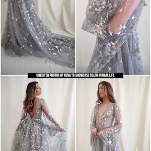 May include: A gray tulle gown with a plunging neckline and long sleeves. The gown is covered in silver and gold stars. The model is wearing the gown and standing in front of a white background. "UNEDITED PHOTOS OF NOVA TO SHOWCASE COLOR IN REAL LIFE" is written in black text at the bottom of the image.