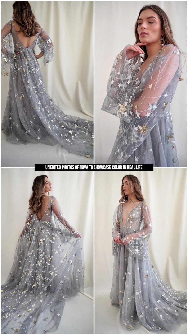 May include: A gray tulle gown with a plunging neckline and long sleeves. The gown is covered in silver and gold stars. The model is wearing the gown and standing in front of a white background. "UNEDITED PHOTOS OF NOVA TO SHOWCASE COLOR IN REAL LIFE" is written in black text at the bottom of the image.