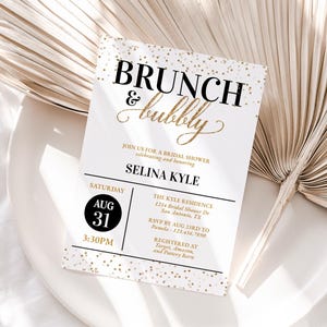 May include: A white bridal shower invitation with gold glitter confetti. The invitation reads "Brunch & Bubbly" in black text with a gold script font for "bubbly". The invitation is for Selina Kyle and is scheduled for Saturday, August 31st at 3:30 PM. The event will be held at The Kyle Residence, 1234 Bridal Shower Dr, San Antonio, TX. RSVP by August 23rd to Pamela at 123.456.7890. The invitation also includes a list of stores where gifts are registered: Target, Amazon, and Pottery Barn.