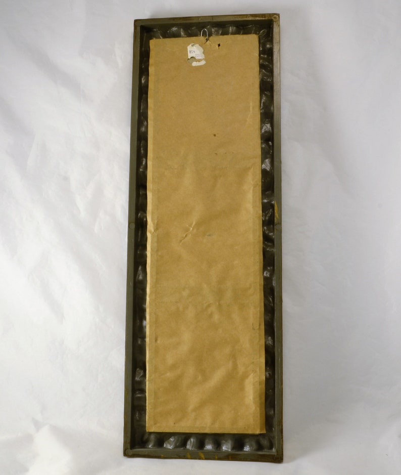May include: A brown rectangular framed picture with a brown paper backing. The frame has a decorative, textured border.