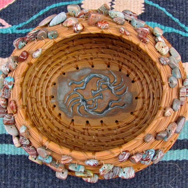 Beautiful natural brown pine needle basket with sky blue jasper chip beads and a whimsical Kokopelli pottery base entitled "Desert Dancers"