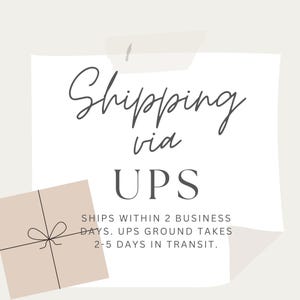 May include: A beige and white graphic with the words "Shipping via UPS". The text is in a handwritten style. A small beige box with a bow is in the lower left corner.