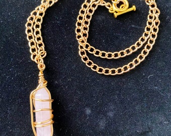 Golden Love wore wrapped crystal necklace