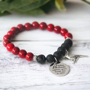 May include: Red and black beaded bracelet with a silver charm that reads "When cardinals appear your loved one is near".