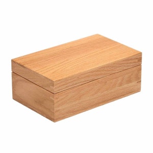 May include: A wooden box with a lid. The box is made of light brown wood with a natural grain pattern.