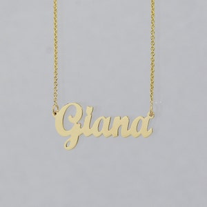 May include: Gold necklace with a cursive nameplate pendant that reads "Giana".
