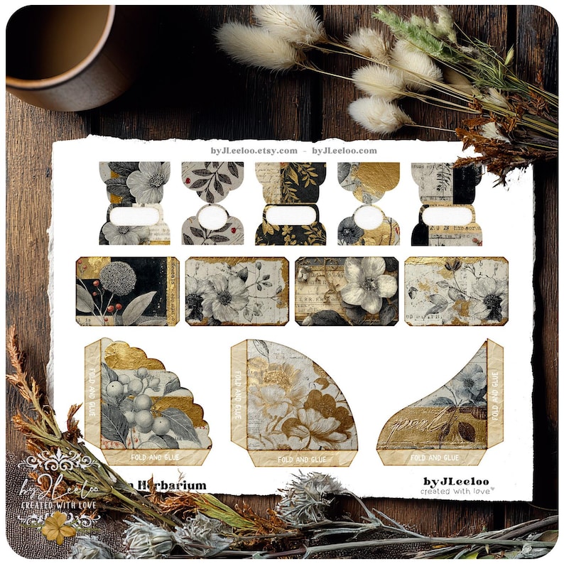 May include: A collection of botanical-themed paper ephemera with floral and foliage designs in black, white, and gold. The set includes various shapes and sizes, such as tags and boxes, with the text "Herbarium" and "by JLeeloo" printed on them.