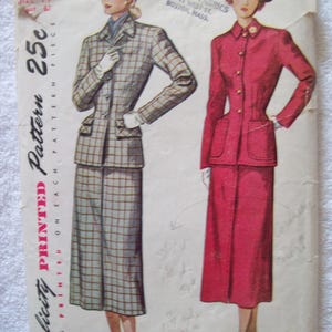 May include: A vintage Simplicity printed pattern envelope number 2574, size 14, featuring illustrations of two skirt suits. One suit is a grey and brown plaid, the other is solid red. The envelope includes text details and distributed by Thresher Fabrics.