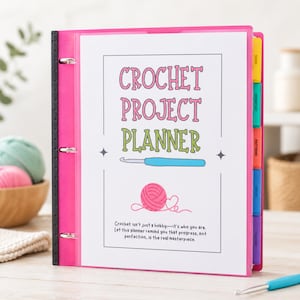 May include: A bright pink three-ring binder featuring a white cover page with the text Crochet Project Planner, a blue crochet hook illustration, a pink yarn ball graphic, and the quote Crochet isn't just a hobby—it's who you are.