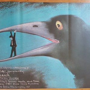 May include: Film poster for "After Hours" showing a man in a suit held in the open beak of a large bird. The background is blue and grey, with Polish text. The poster is a work of art.