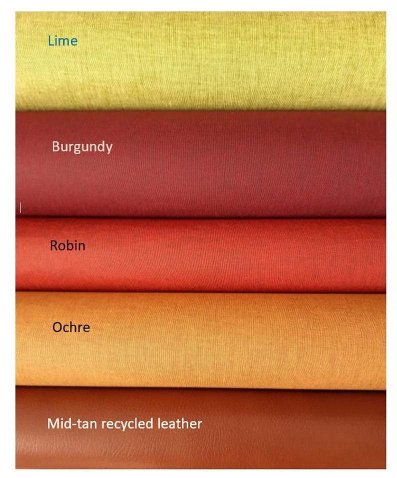 May include: Five horizontal rolls of material stacked vertically. The colors are labeled as Lime, Burgundy, Robin, Ochre, and Mid-tan recycled leather. Each roll displays a distinct texture and solid color, ranging from yellow-green to deep red and brown.