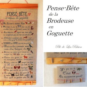 Peut inclure: Un sampler brodé encadré avec le titre "Pense-Bête de la Brodeuse en Goguette" et le texte "Se lever avec les... Pour qu'il ne prenne pas la..."  Le sampler est sur un cadre en bois avec une ficelle rouge attachée au sommet. Le sampler est sur un fond blanc.