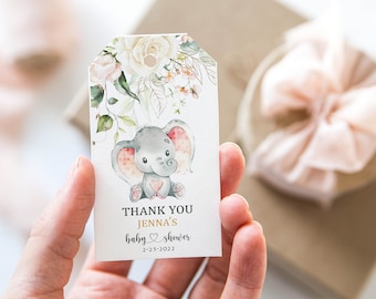 May include: Thank you tag with a watercolor illustration of a baby elephant with pink ears and a pink heart. The tag has the text "Thank You Jenna's Baby Shower 2-23-2022" in gold lettering.