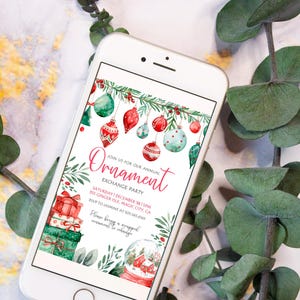 May include: A digital invitation for a Christmas ornament exchange party. The invitation features a watercolour illustration of ornaments, a snow globe, and presents. The text reads "Ornament Exchange Party" and includes the date, time, location, and RSVP information.