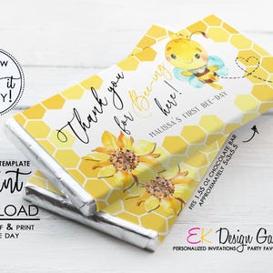 May include: A chocolate bar wrapper with a bee theme. The wrapper features a cartoon bee, sunflowers, and a honeycomb pattern. Text includes "Thank you for Bee-ing here!" and "Malissa's First Bee-Day". The bar fits a 1.55 oz chocolate bar, approximately 5x3x5.5 inches.
