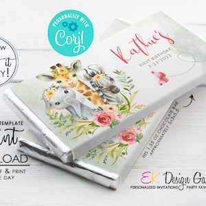 May include: Editable template for a chocolate bar wrapper featuring a watercolor illustration of a giraffe, zebra, and elephant with floral accents. The text "Kathie's First Birthday 7-23-2022" is printed on the wrapper. The wrapper fits a 1.55 oz chocolate bar.