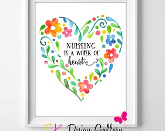 May include: A watercolor print with a heart-shaped floral design. The heart is filled with colorful flowers and leaves. The text "Nursing is a work of heart" is written inside the heart.