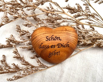 Wooden heart with engraving, hand flatterer