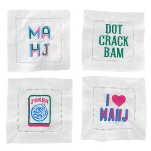 four square images, each with a different embroidered design or text. The first image features the letters "MA HJ" in a colorful, embroidered style. The second image displays the phrase "DOT CRACK BAM" in green embroidered letters. The third image shows a "JOKER" card with a joker symbol and the word "JOKER" written on it. The fourth image shows the phrase "I <3 MAHJ" in pink embroidered letters, with a heart symbol and the word "I" written below it.