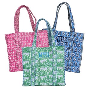three colorful tote bags with different patterns and colors.