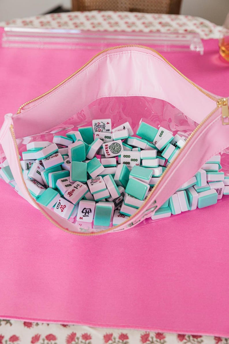 a pink table with a pink and white table cloth and a pink purse filled with