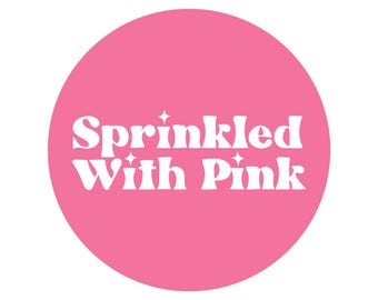 May include: A pink circle with the text "Sprinkled With Pink" in white.