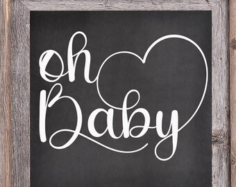 May include: A rustic wooden framed chalkboard sign with the text "Oh Baby" in white cursive lettering with a heart shape drawn around the word "Baby".