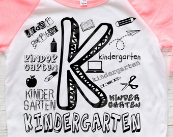 May include: A white and pink baseball tee shirt with black text and graphics that say "kindergarten" and features a large black letter "K".