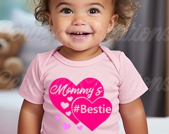 May include: A pink baby onesie with a pink heart design that says "Mommy's #Bestie".