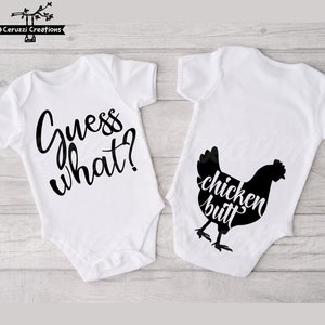 May include: Two white baby onesies. One has the text "Guess what?" in black script. The other has a black chicken silhouette with the words "chicken butt" in a playful font. Perfect for a baby shower gift.