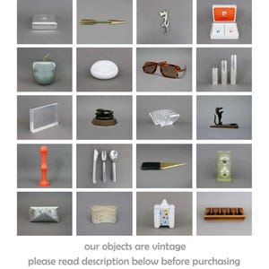May include: A collection of vintage items arranged in a grid. The items include a silver box, a gold arrow, a silver dragon, a red and white box, a green apple, a white dish, a pair of brown sunglasses, two silver containers, a clear acrylic frame, a stack of black and brown discs, a clear acrylic napkin holder, a black metal dog figurine, a red plastic object, a set of silver cutlery, a black and silver letter opener, a clear glass hourglass, a silver box, a white sponge, a white ceramic house, and a wooden box with four compartments.