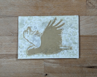 Hand-bound notebook with cardboard cover illustrated with a golden cockatoo in screen printing and watercolor