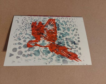 Hand-bound notebook with cardboard cover illustrated with a red parrot in screen printing and watercolor