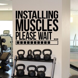 May include: Black and white gym wall decal with the text "Installing Muscles Please Wait..." and a progress bar.
